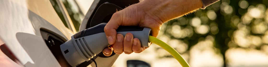 Man recharging his EV