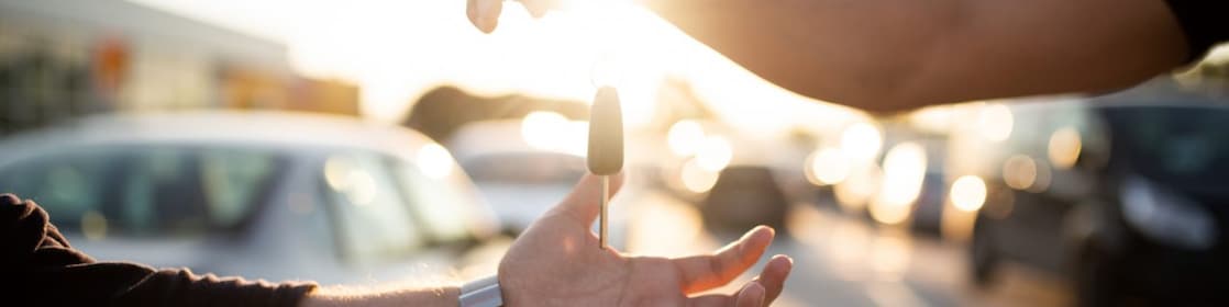 Person handing over keys to another person