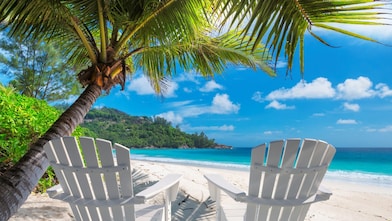 Two empty chairs on a beach