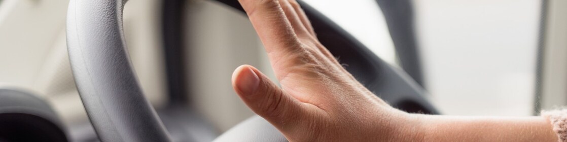 Hand on steering wheel