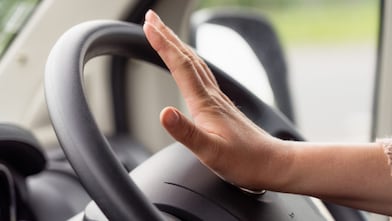 Hand on steering wheel