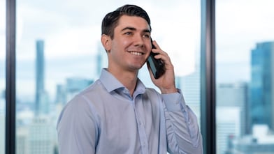 An individual holding a cellphone to his ear