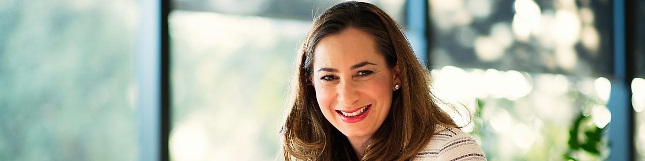 Lucia Lombardo smiling at camera in the office