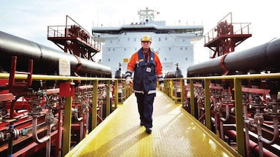 worker walking around a Shell vessel