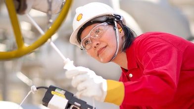 female employee inspecting equipment