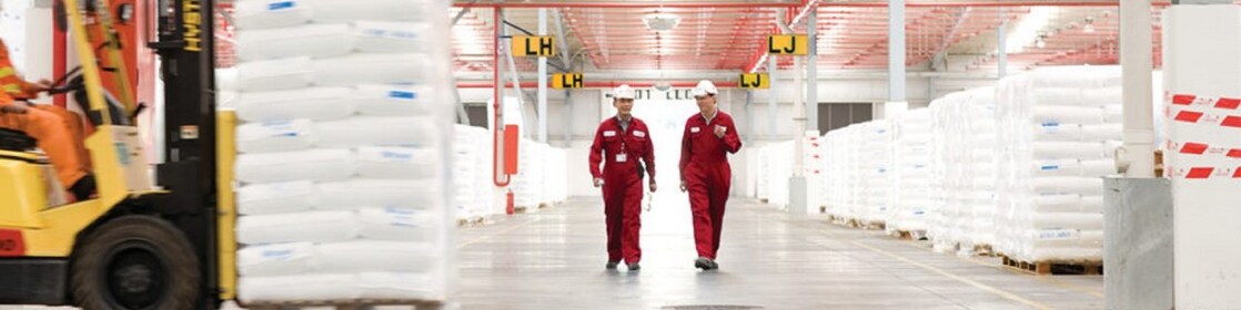 Two employees walking in a factory