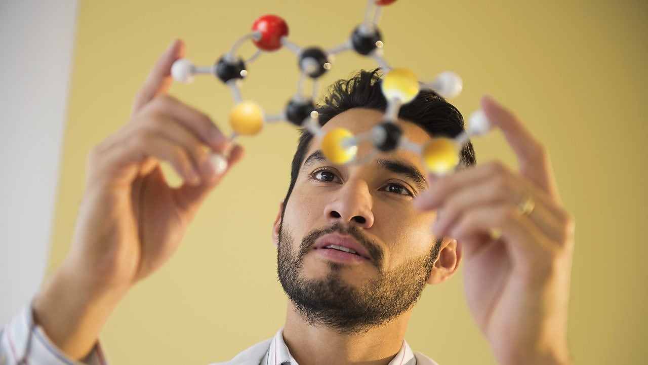 Business man examining molecules