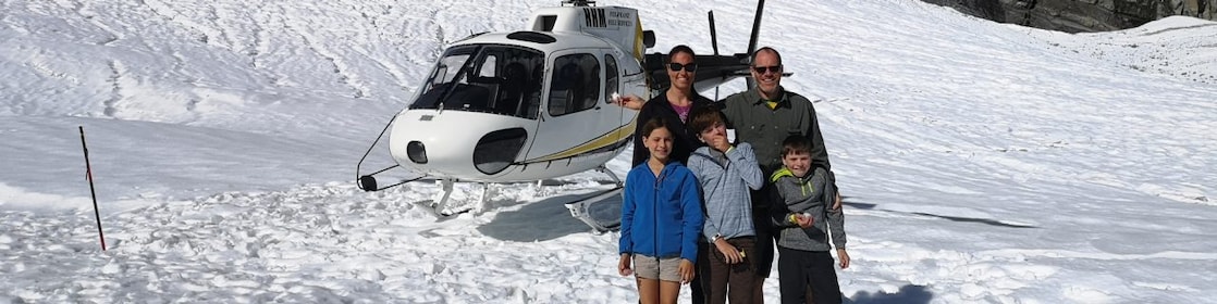 family in front of a helicopter