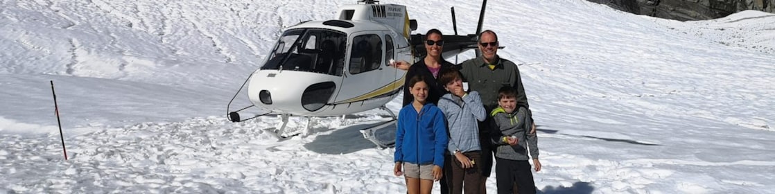 family in front of a helicopter