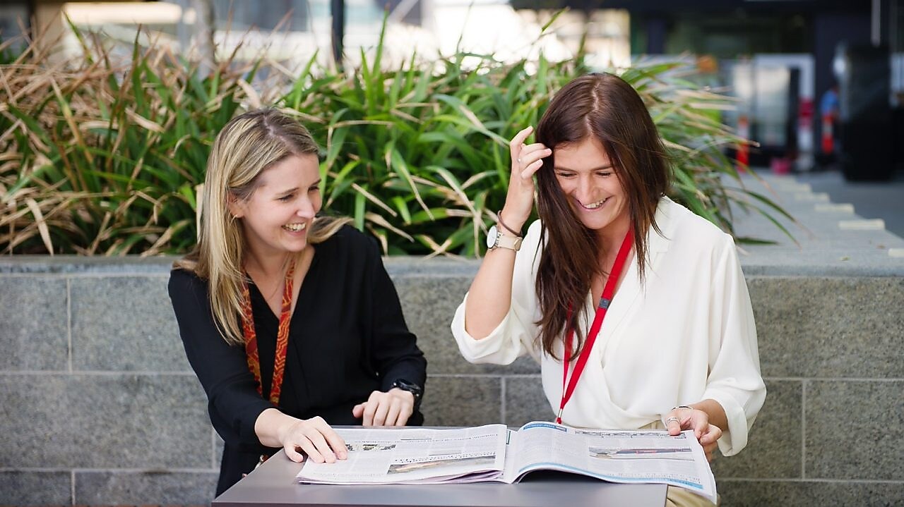 Two women discussing and laughing