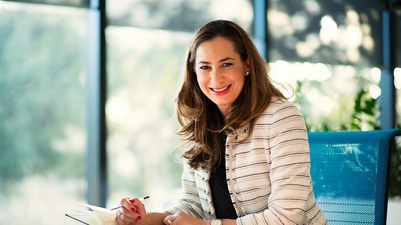 Lucia Lombardo smiling at camera in the office