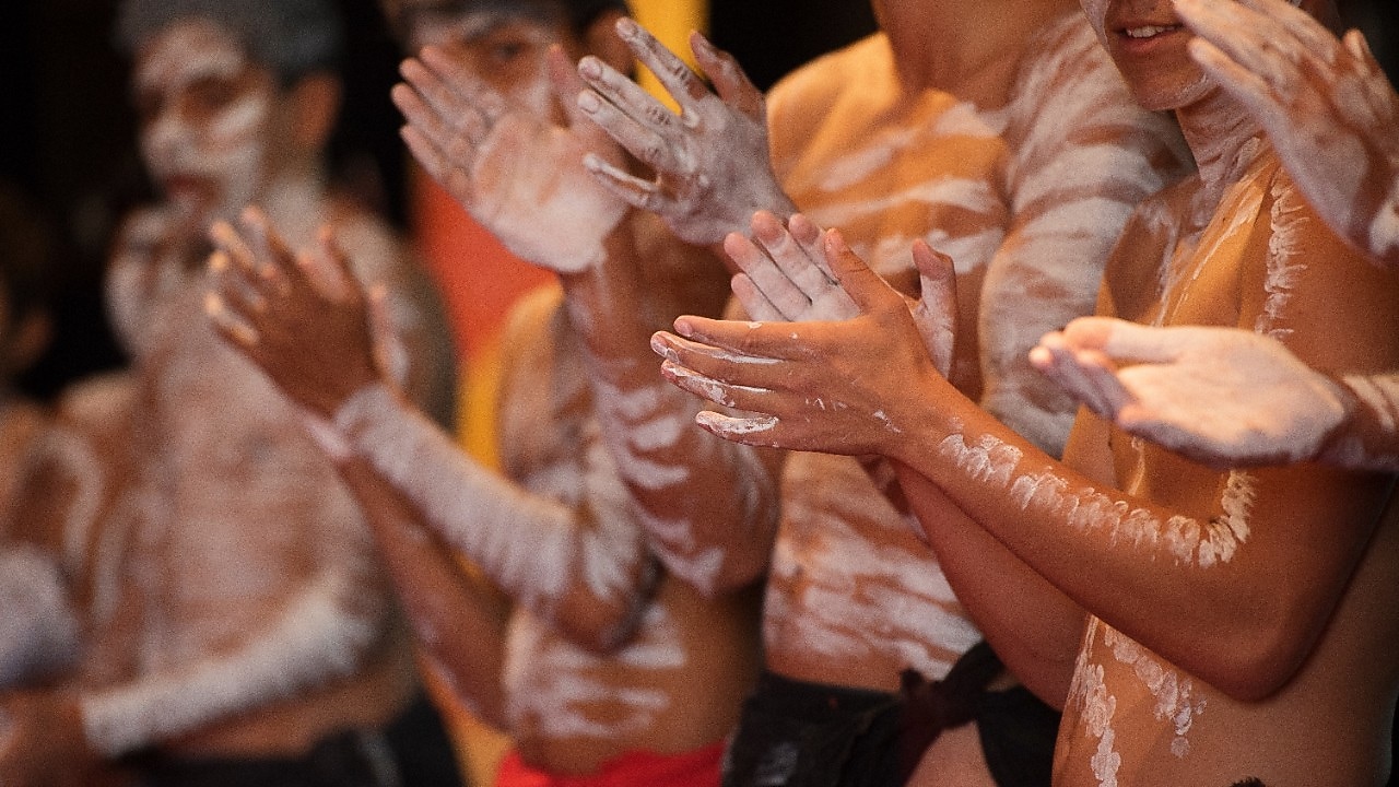 a-group-of-men-with-white-body-paint-clapping