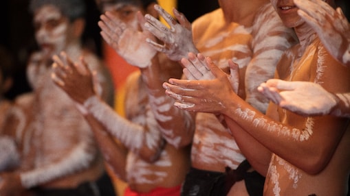 a-group-of-men-with-white-body-paint-clapping