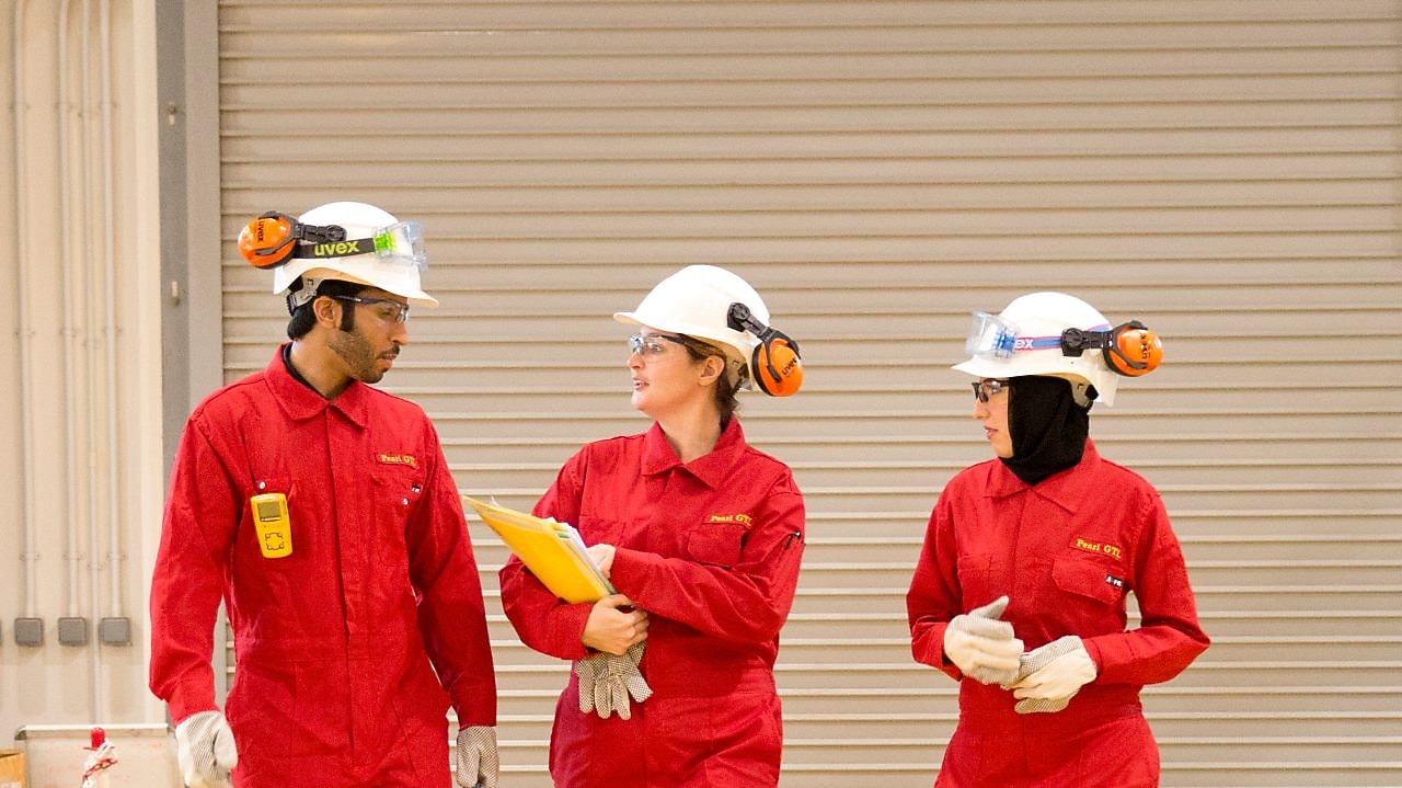Staff in safety gear walking on site at Pearl GTL Plant, Qatar