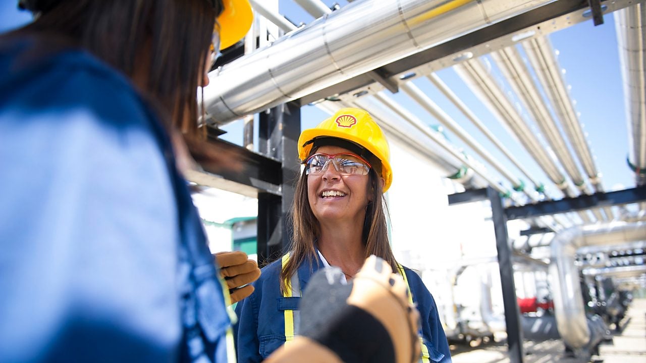 Female colleagues on site talking and smiling