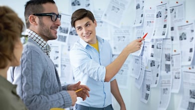 Students looking the newspaper ads