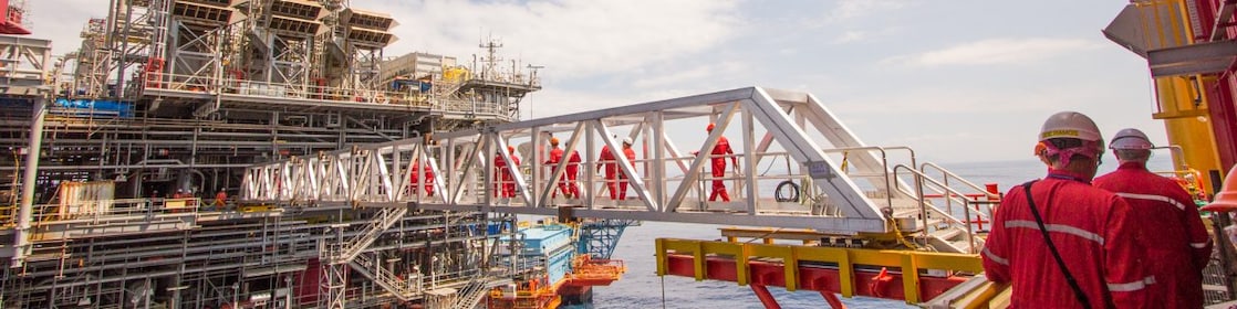 Workers cross over to a new platform built alongside the existing Malampaya deep-water project