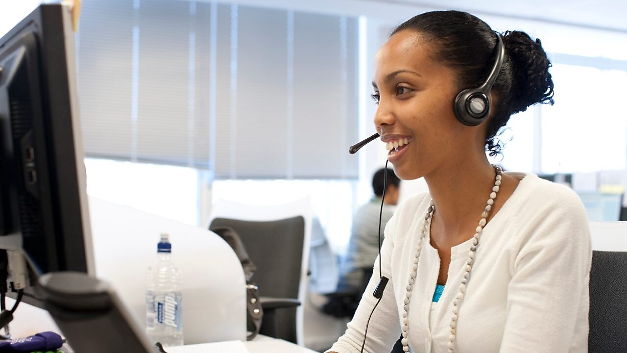 Woman in call centre facing her computer screen
