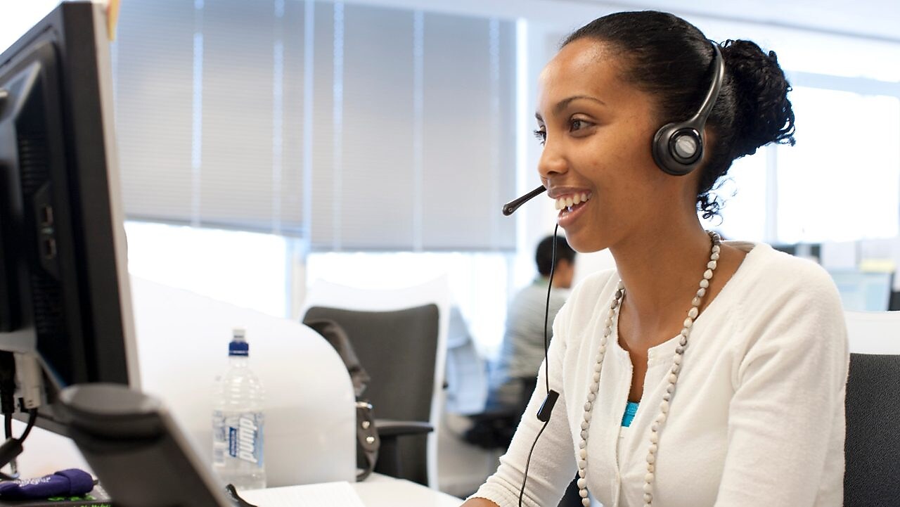 Woman in call centre facing her computer screen