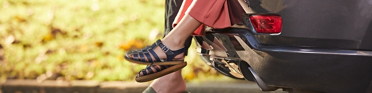 Two people chilling in backseat of car