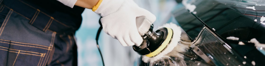 Workers are polishing car lights in factory