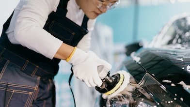 Workers are polishing car lights in factory