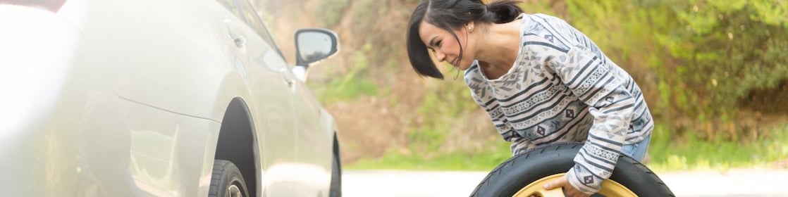 Woman changing a tyre