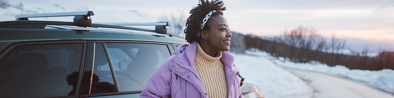 Photo of a young African American woman on a winter road trip.