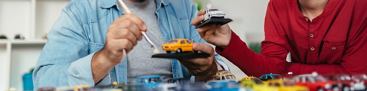 Father and son painting mini model cars