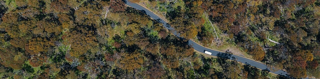 birds eye view of car driving along a rural road
