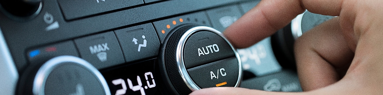 man hand turning on car air conditioning system