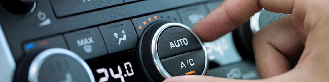 man hand turning on car air conditioning system