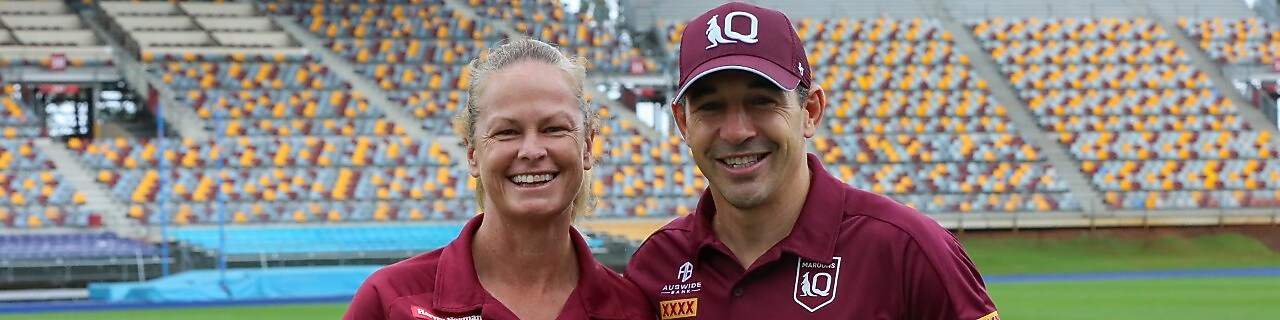 Queensland Maroons head coach Billy Slater stands in a stadium side-by-side with Tahnee Norris, head coach of Queensland’s women’s State of Origin team.
