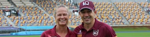 Queensland Maroons head coach Billy Slater stands in a stadium side-by-side with Tahnee Norris, head coach of Queensland’s women’s State of Origin team.