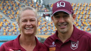 Queensland Maroons head coach Billy Slater stands in a stadium side-by-side with Tahnee Norris, head coach of Queensland’s women’s State of Origin team.