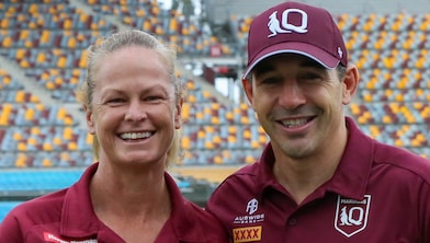 Queensland Maroons head coach Billy Slater stands in a stadium side-by-side with Tahnee Norris, head coach of Queensland’s women’s State of Origin team.