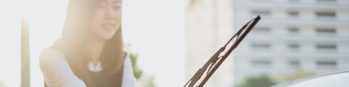 woman fixing front windscreen wiper blade