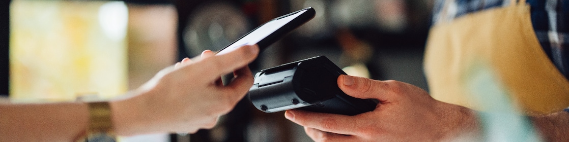 Flybuys for Shell: hand tapping phone on POS machine