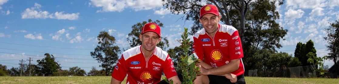 Race team member planting a tree in a park