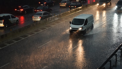 White van driving in the rain at night