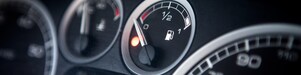 Close up of a car dashboard fuel tank reading