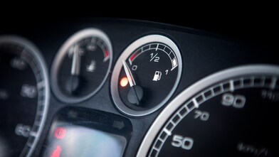 Close up of a car dashboard fuel tank reading