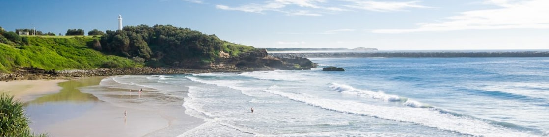 Seaside pool at Yamba beach, with lighthouse in the distance