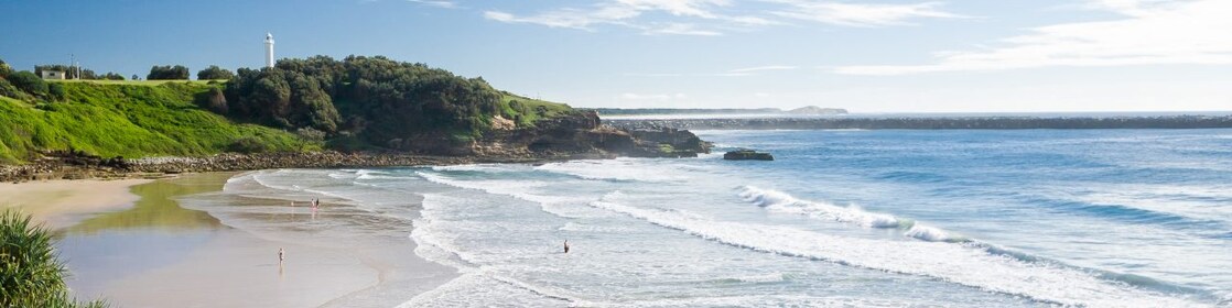 Seaside pool at Yamba beach, with lighthouse in the distance