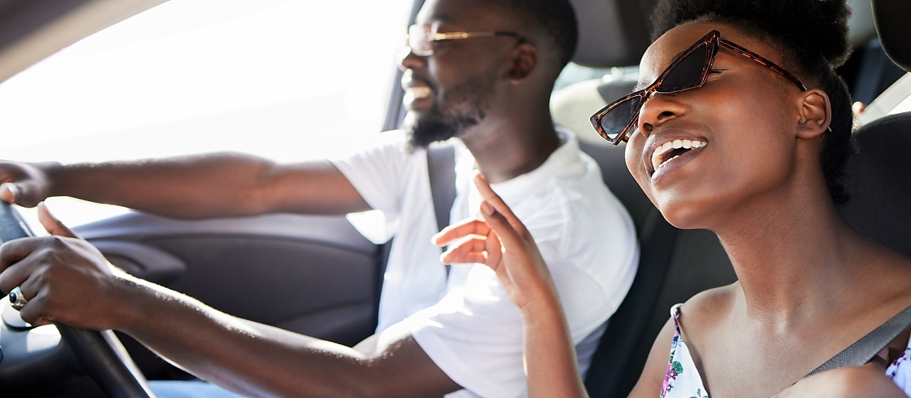 2 people sitting in the car listening to music