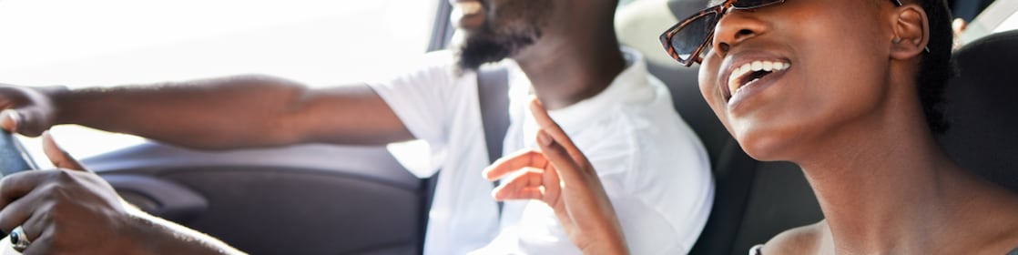2 people sitting in the car listening to music