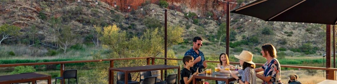 Family of four enjoying meal outdoors