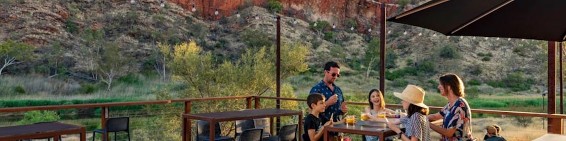 Family of four enjoying meal outdoors