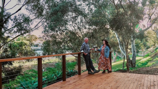 two people enjoying wine on veranda