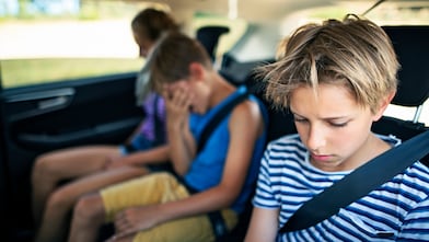 Car trip with three kids. Kids getting bored from long trips and nauseous from car sickness.